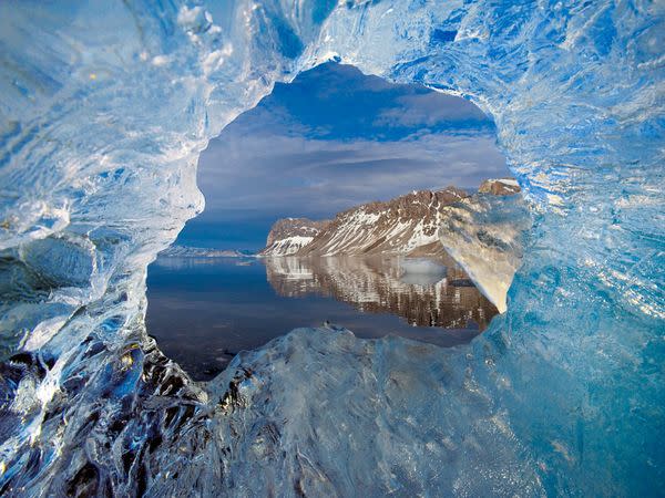 A hole in glacier ice frames Hornsund, Spitsbergen. Vikings may have found the far-flung islands of Svalbard as early as the 12th century.