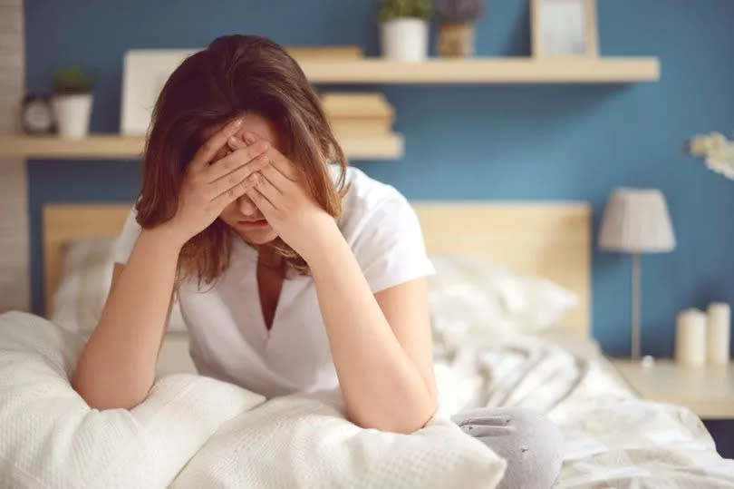 Unhappy girl in a bedroom