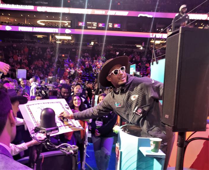 Kansas City wide receiver JuJu Smith-Schuster plays Pin the Tail on the Donkey while wearing a cowboy hat during Opening Night for Super Bowl 57 at the Football Printer Center on Feb.  6, 2023.