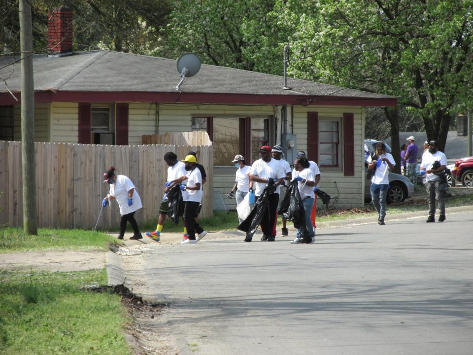 Volunteers help pick up trash during a community cleanup in the Massey Hill neighborhood Saturday, March 27, 2021, in Fayetteville.