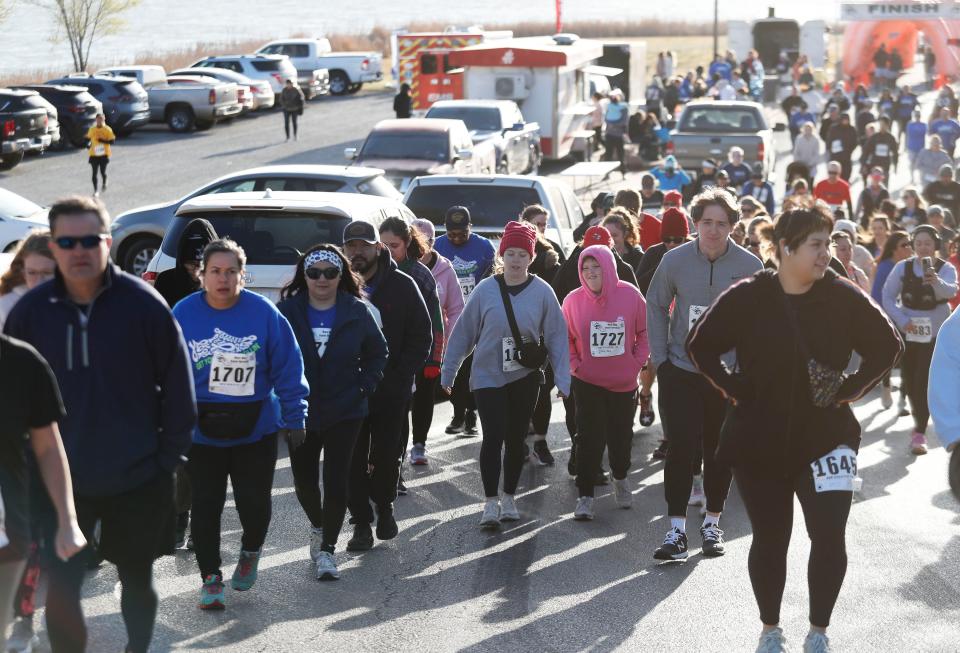 Runners walk up to the starting line before the run. Runners competed in the 2023 Lubbock Undy Run at Mae Simmons Park Saturday, Mar. 25, 2023 to benefit the Colorectal Cancer Alliance.