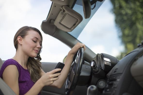 Woman texting while driving