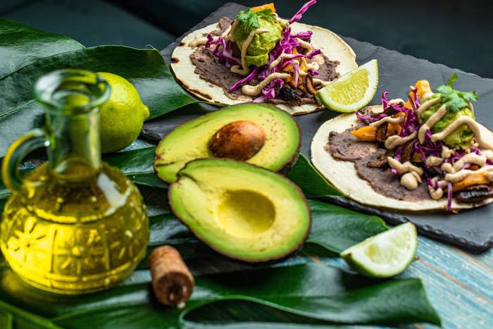 Avocado and tacos from Brooklyn's Kokomo on a green table