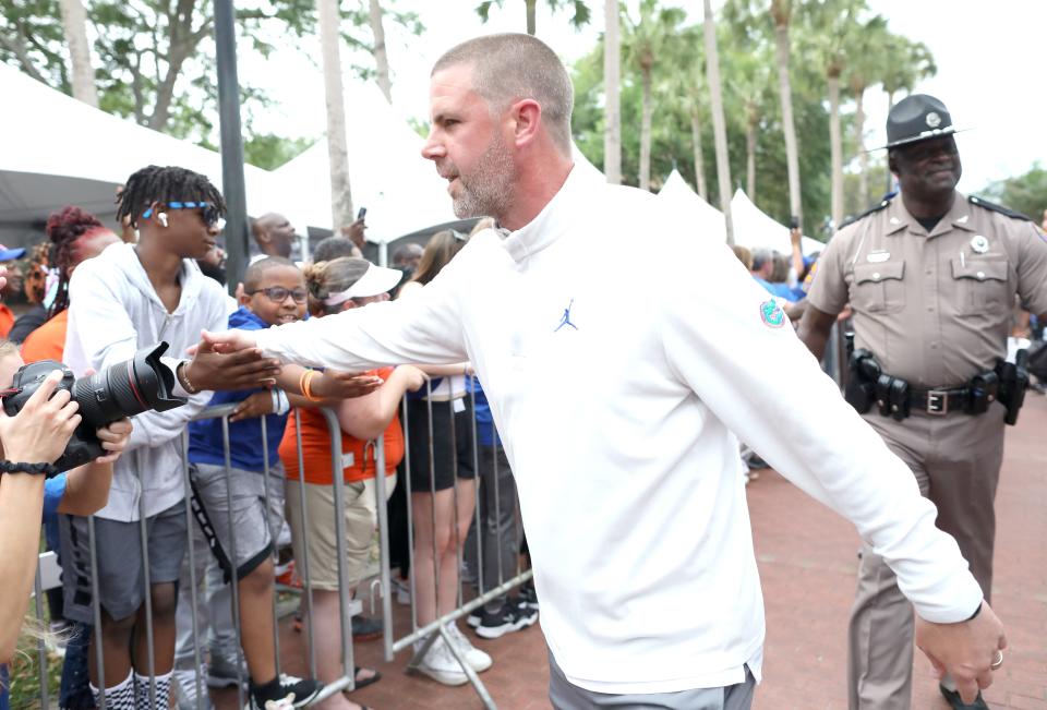 Florida Gators head coach Billy Napier slaps hand with fans during the Gator Walk before the annual Orange and Blue spring game  at Ben Hill Griffin Stadium in Gainesville Fla. April 14, 2022.   [Brad McClenny/The Gainesville Sun]   