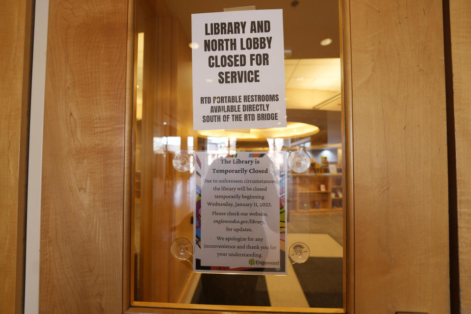 Signs are placed on the outside doors to advise visitors that the library as well as a restroom are closed because of meth contamination Thursday, Jan. 12, 2022, in the south Denver suburb of Englewood, Colo. (AP Photo/David Zalubowski)