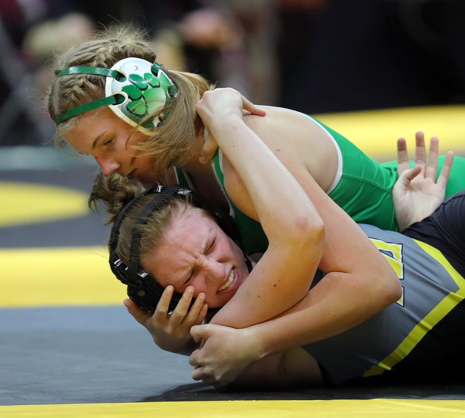 Mia Gaetjens of Mogadore, top, works over Emma Watkins of Watkins Memorial at the state meet.