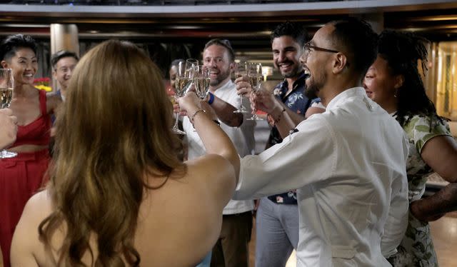 <p>David Moir / Bravo</p> Danny Garcia cheers with the Top Chef judges and finalists.