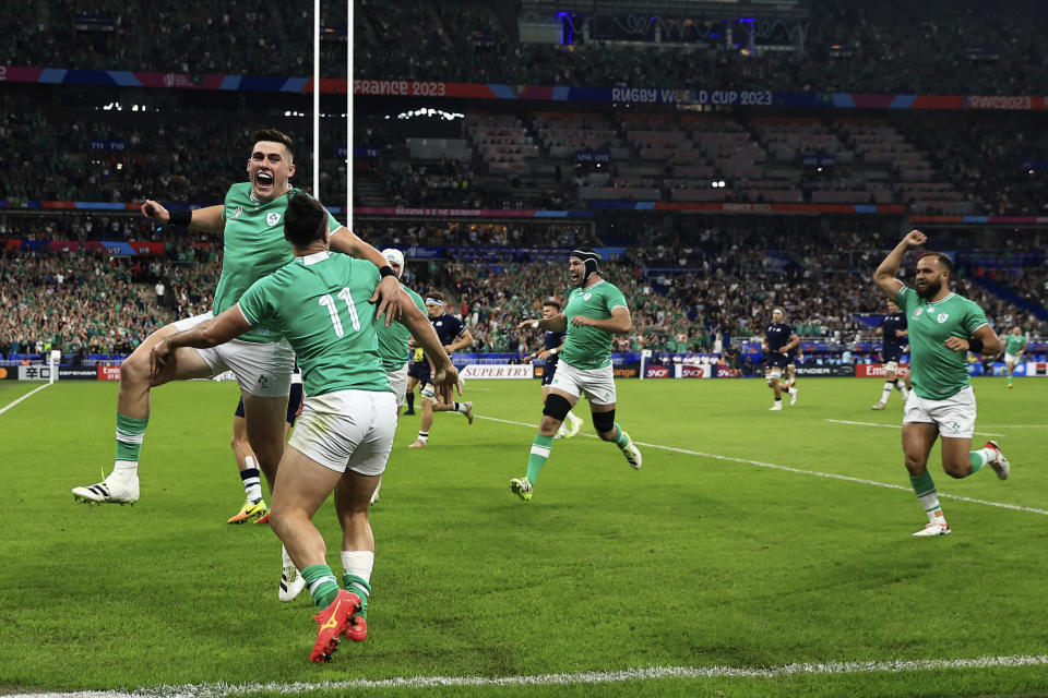 Ireland's James Lowe, front, celebrates after scoring a try with Ireland's Dan Sheehan, left, during the Rugby World Cup Pool B match between Ireland and Scotland at the Stade de France in Saint-Denis outside of Paris, Saturday, Oct. 7, 2023. (AP Photo/Aurelien Morissard)