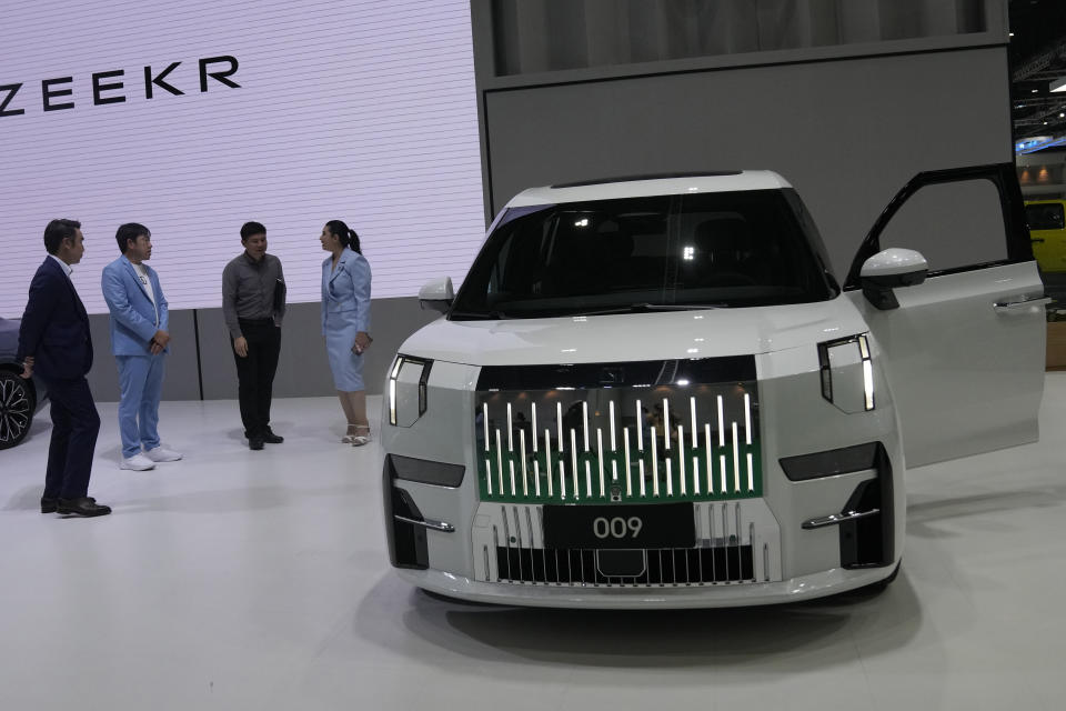 Visitors look at ZEEKR's electric vehicles "009" during the 45th Bangkok Motor Show in Nonthaburi, Thailand, Tuesday, March 26, 2024. (AP Photo/Sakchai Lalit)