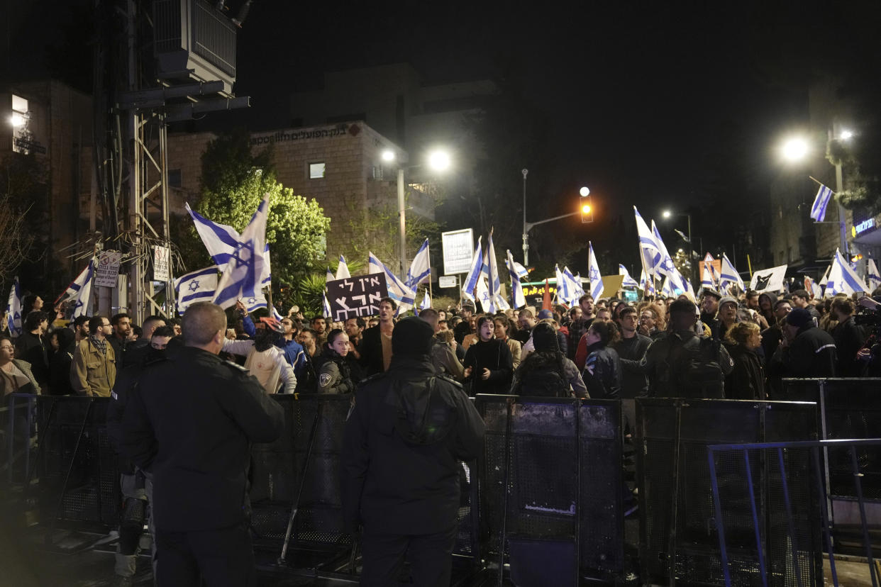 Israelis opposed to Prime Minister Benjamin Netanyahu's judicial overhaul plan protest outside of his home after the Israeli leader fired his defense minister, in Jerusalem, Sunday, March 26, 2023. Defense Minister Yoav Gallant had called on Netanyahu to freeze the plan, citing deep divisions in the country and turmoil in the military. (AP Photo/ Mahmoud Illean)