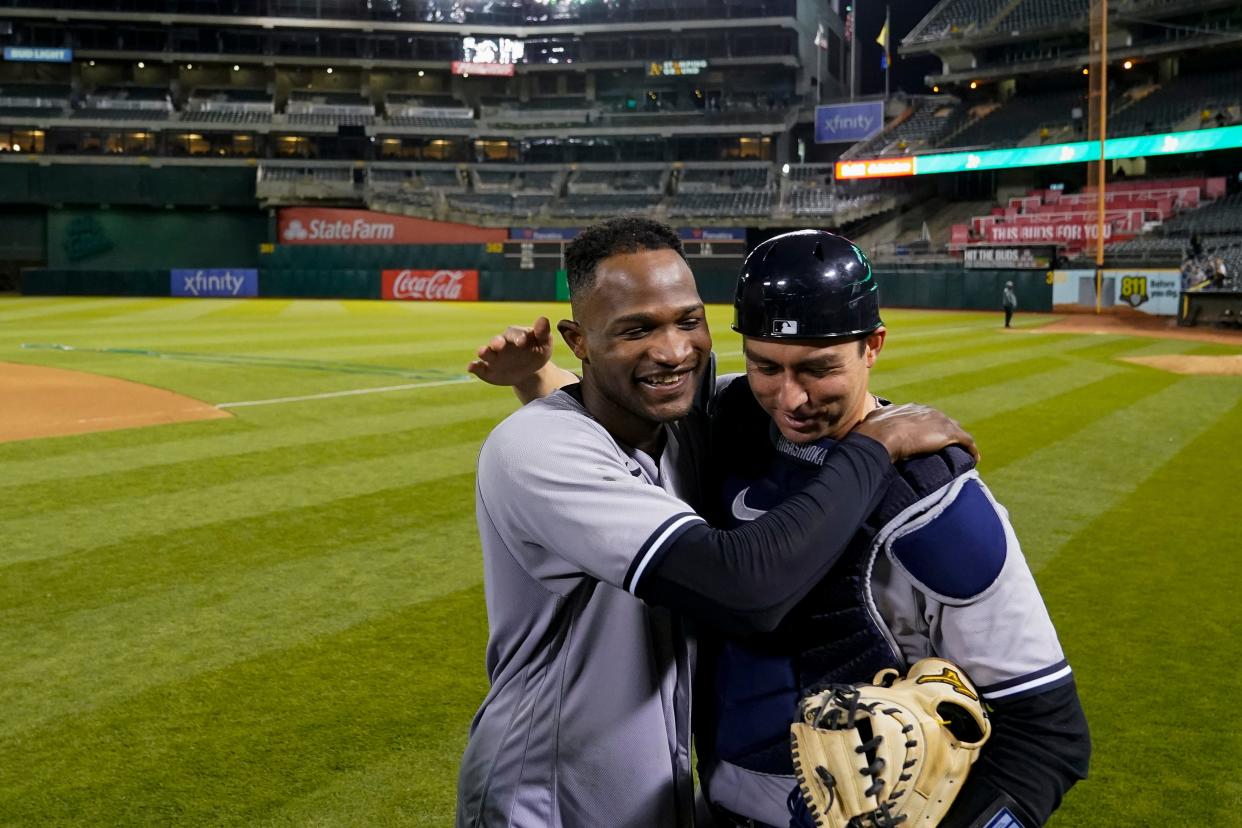 New York Yankees pitcher Domingo Germán, left, celebrates with catcher Kyle Higashioka after he pitched a perfect game against the Oakland Athletics in a baseball game in Oakland, Calif., Wednesday, June 28, 2023. (AP Photo/Godofredo A. Vásquez)