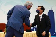 Taiwan's Deputy Economy Minister Chen Chern-chyi and Indiana Governor Eric Holcomb shake hands after signing a MOU