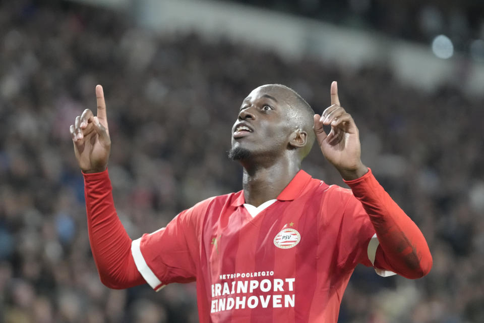 PSV's Jordan Teze celebrates after scoring his side's second goal during the Group B Champions League soccer match between PSV and Sevilla at Philips stadium in Eindhoven, Netherlands, Tuesday, Oct. 3, 2023. (AP Photo/Peter Dejong)