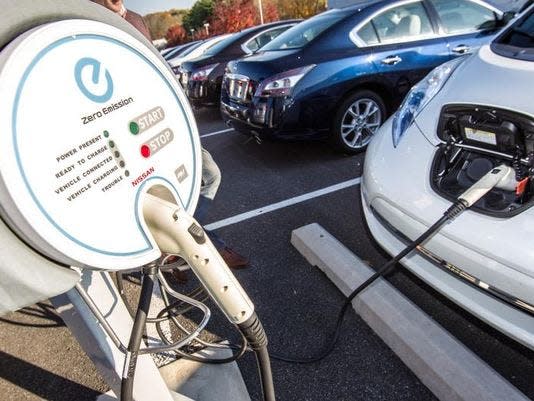 An electric car charges at Porter Nissan in Newark in 2013. Delaware signed on to a goal in 2023 to gradually phase out all gas-powered cars by 2032.