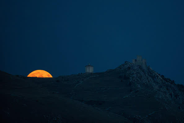 Harvest moon shining behind Rocca Calascio Castle, Abruzzo, Italy.