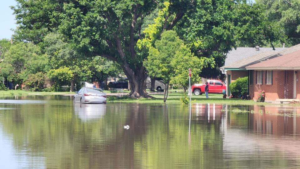 Flooding is seen Thursday on Mockingbird Lane near Lawrence Lake in Amarillo after heavy rain overnight Wednesday. Emergency personnel were on hand to help those impacted in the area.