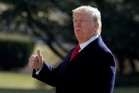 U.S. President Donald Trump gestures as he walks on South Lawn of the White House in Washington, U.S., before his departure to the Customs and Border Protection National Targeting Center, February 2, 2018. REUTERS/Yuri Gripas