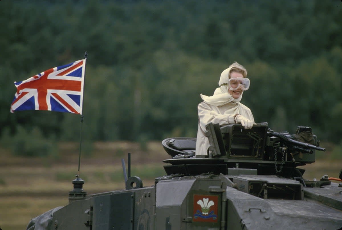 Margaret Thatcher showing off her googles while riding a British tank in West Germany (Getty Images)