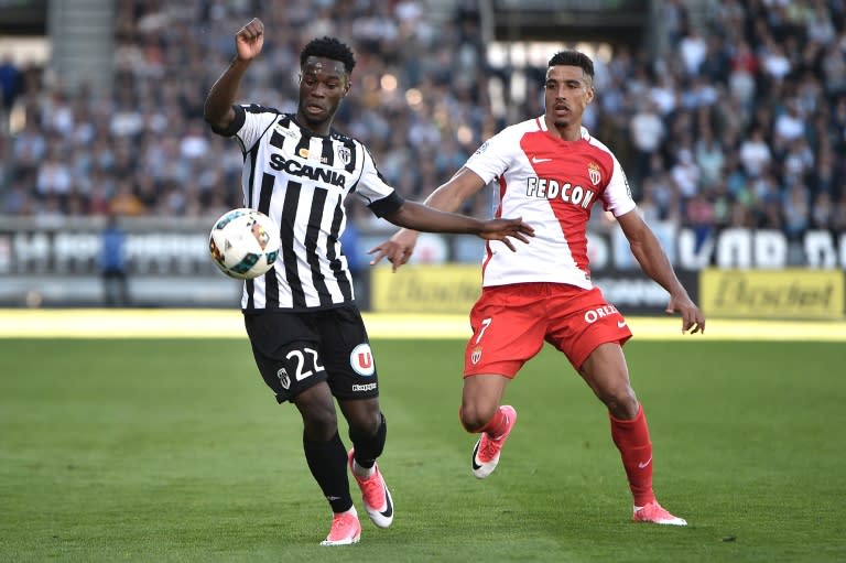 Angers' Jonathan Bamba (L) vies with Monaco' Nabil Dirar during their match on April 8, 2017, at the Raymond Kopa Stadium in Angers, western France