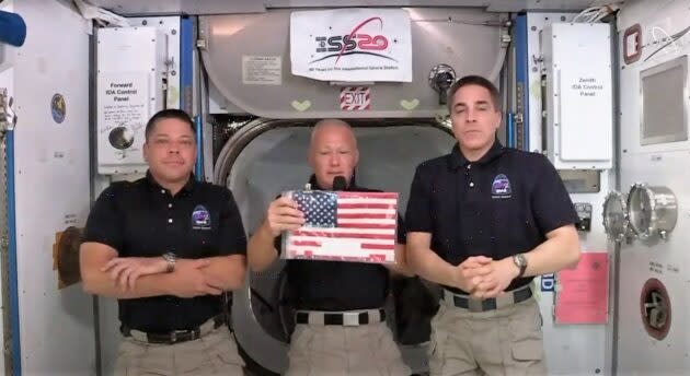 Behnken, Hurley and Cassidy with flag