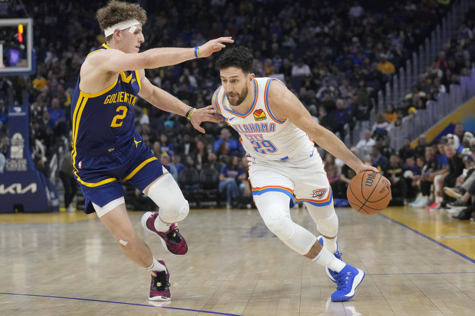 Oklahoma City Thunder guard Vasilije Micic (29) drives to the basket against Golden State Warriors guard Brandin Podziemski (2) during the first half of an NBA basketball game in San Francisco, Saturday, Nov. 18, 2023. (AP Photo/Jeff Chiu)