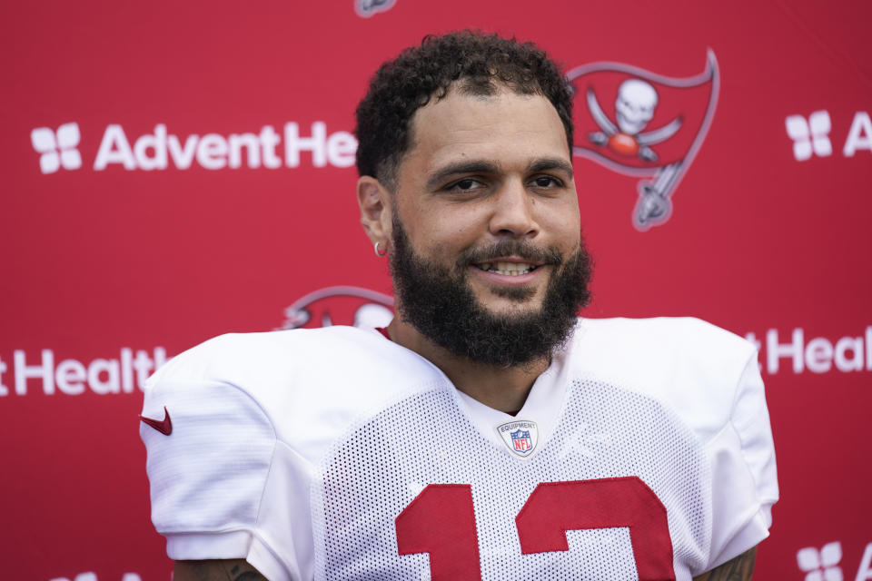 FILE - Tampa Bay Buccaneers' Mike Evans talks with reporters after a joint practice with the New York Jets at the Jets' training facility in Florham Park, N.J., Wednesday, Aug. 16, 2023. Tampa Bay receiver Mike Evans has agreed to a two-year, $52 million contract to remain with the Tampa Bay Buccaneers instead of testing his worth in free agency, a person familiar with the deal told The Associated Press. The person spoke to the AP on condition of anonymity Monday, March 4, 2024, because the contract had not been finalized.(AP Photo/Seth Wenig, File)