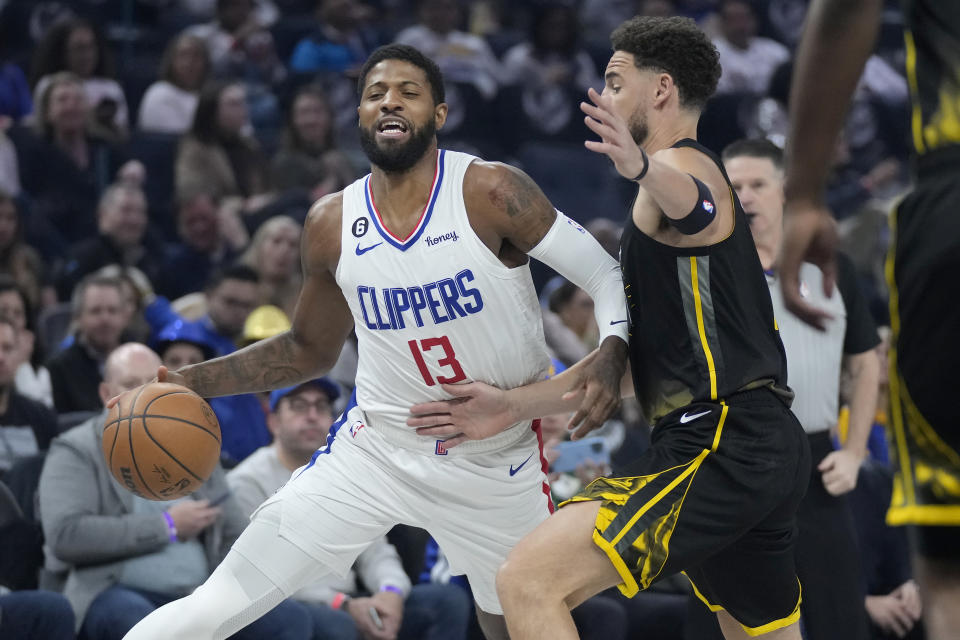 Los Angeles Clippers forward Paul George (13) drives to the basket against Golden State Warriors guard Klay Thompson during the first half of an NBA basketball game in San Francisco, Thursday, March 2, 2023. (AP Photo/Jeff Chiu)
