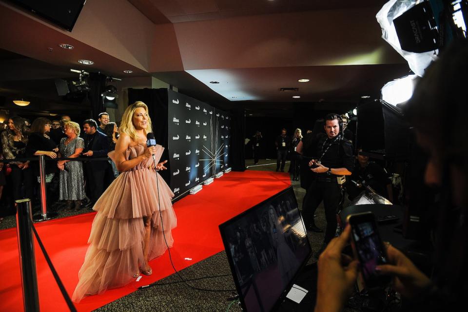 Cheryl Hickey, longtime host of ET Canada, speaks to the camera on the red carpet of the 2019 Canadian Country Music Awards at Scotiabank Saddledome in Calgary. ET Canada will end on Oct. 6 after 18 seasons. (Getty Images/Derek Leung - image credit)