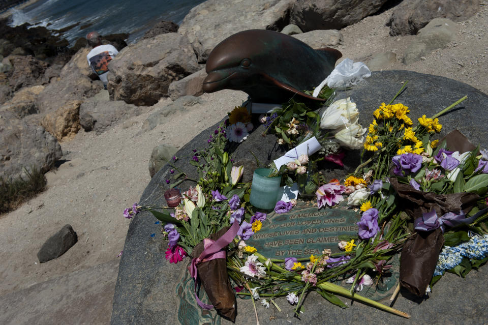 A man looks out into the ocean as he sits by a memorial placed for the victims of the Conception and people lost at sea at the Santa Barbara harbor on Wednesday, Sept. 4, 2019 in Santa Barbara, Calif. A fire raged through the boat carrying recreational scuba divers anchored near an island off the Southern California Coast on Monday, leaving multiple people dead. (AP Photo/Christian Monterrosa)