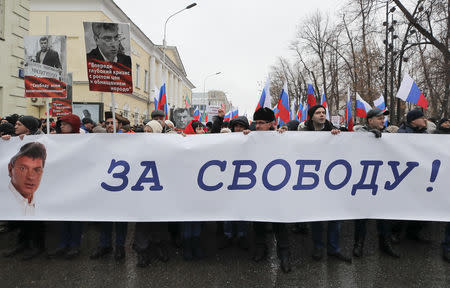 People attend a rally in memory of Russian opposition politician Boris Nemtsov, who was assassinated in 2015, in Moscow, Russia February 24, 2019. The banner reads "For freedom!" REUTERS/Maxim Shemetov