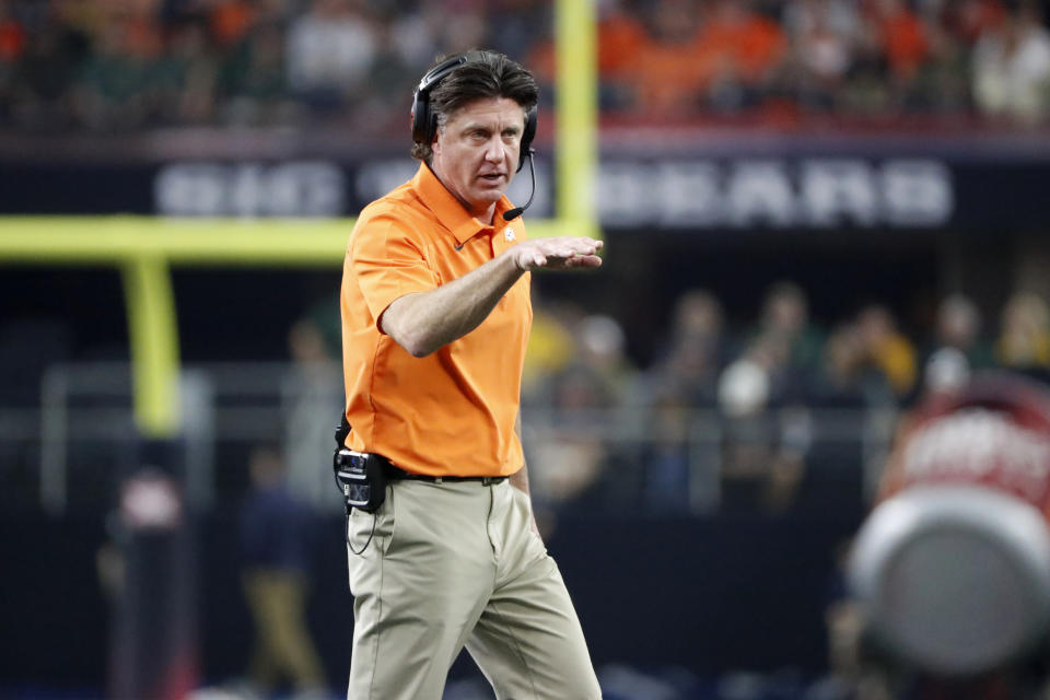 Oklahoma State head coach Mike Gundy watches play from the sideline during the first half of the Big 12 Championship NCAA college football game against Baylor in Arlington, Texas, Saturday, Dec. 4, 2021. (AP Photo/Roger Steinman)