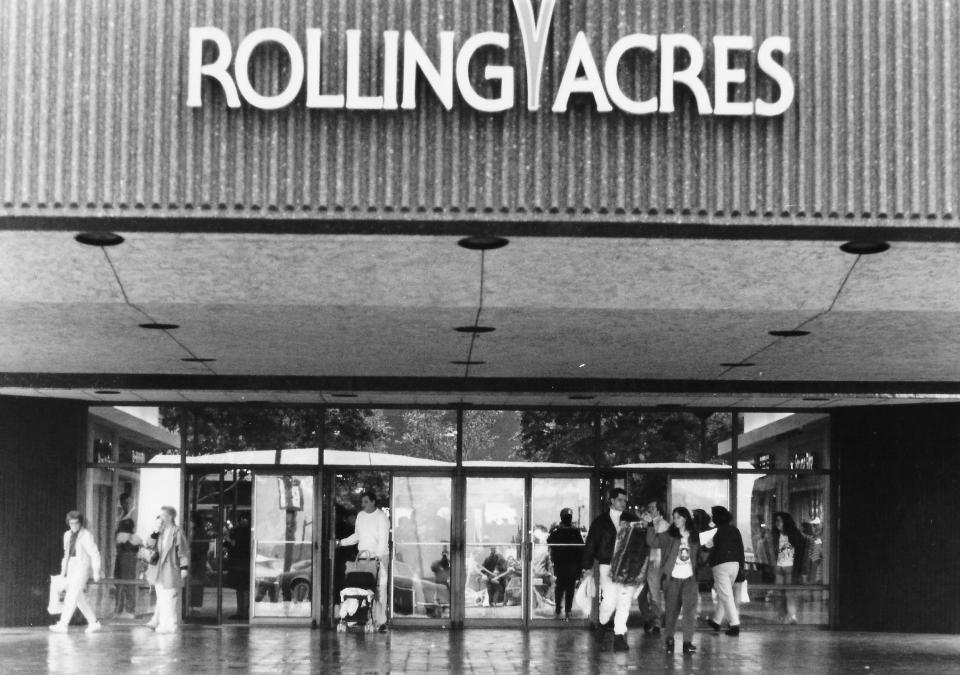 Akron shoppers exit the main entrance of Rolling Acres Mall in 1992 after making purchases.