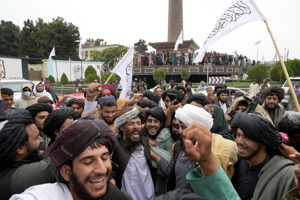 Taliban fighters celebrate one year since they seized the Afghan capital, Kabul, in front of the U.S. Embassy in Kabul, Afghanistan, Monday, Aug. 15, 2022. The Taliban marked the first-year anniversary of their takeover after the country's western-backed government fled and the Afghan military crumbled in the face of the insurgents' advance. (AP Photo/Ebrahim Noroozi)