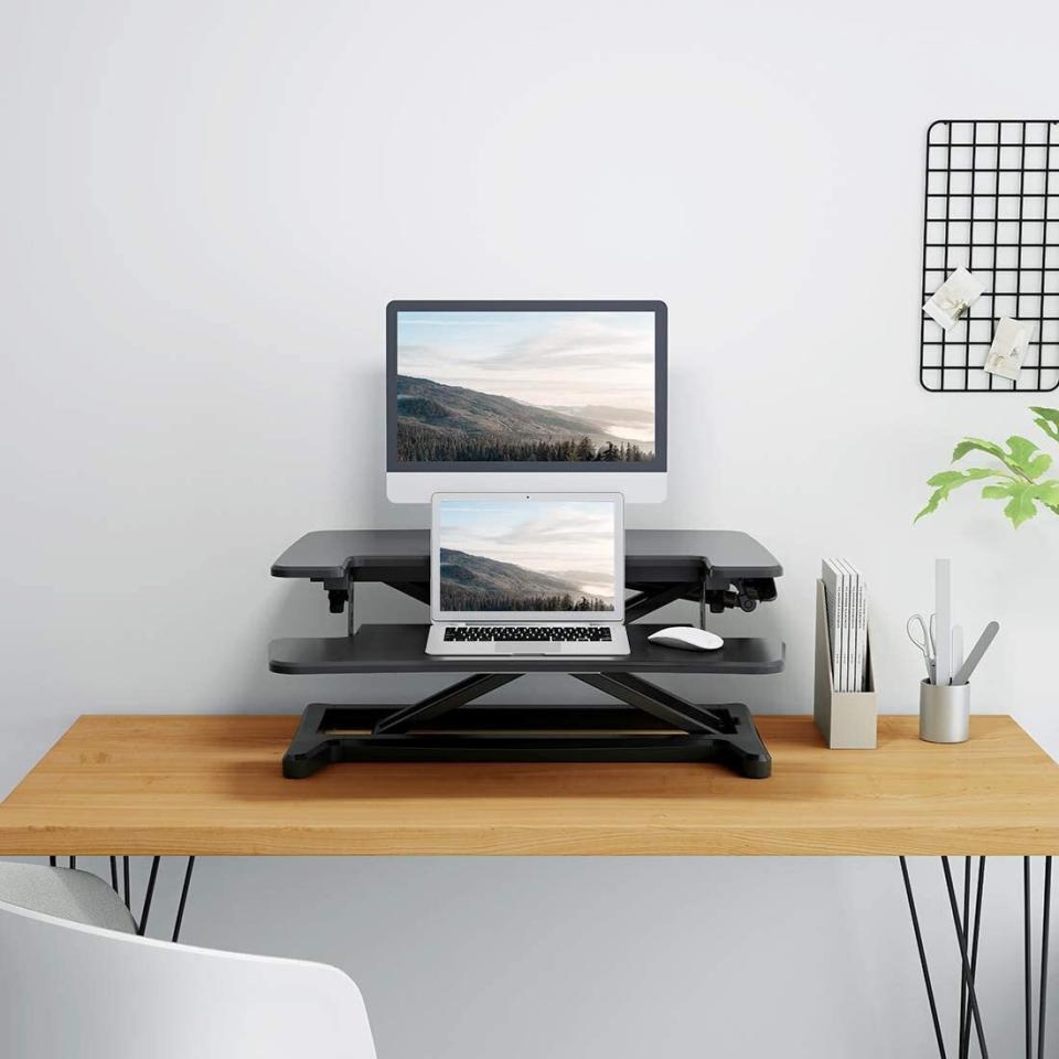 Find this <a href="https://amzn.to/3cwoRp4" target="_blank" rel="noopener noreferrer">Flexispot stand-up desk converter 28-inch standing desk riser</a> for $140 at <a href="https://amzn.to/3cwoRp4" target="_blank" rel="noopener noreferrer">Amazon</a>.<br /><strong>Ratings</strong>: 4.7 stars<br /><strong>Reviews</strong>: More than 300