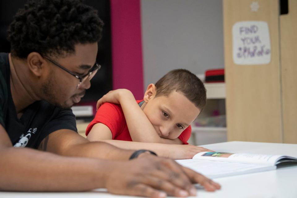 Professional mentor Rakim Isaacs, left, assists Landon Rodriguez in a reading exercise at Friends of the Children as part of a tutoring program. Rodriguez needs extra help because of his dyslexia diagnosis but is unable to get it at the public school he attends.