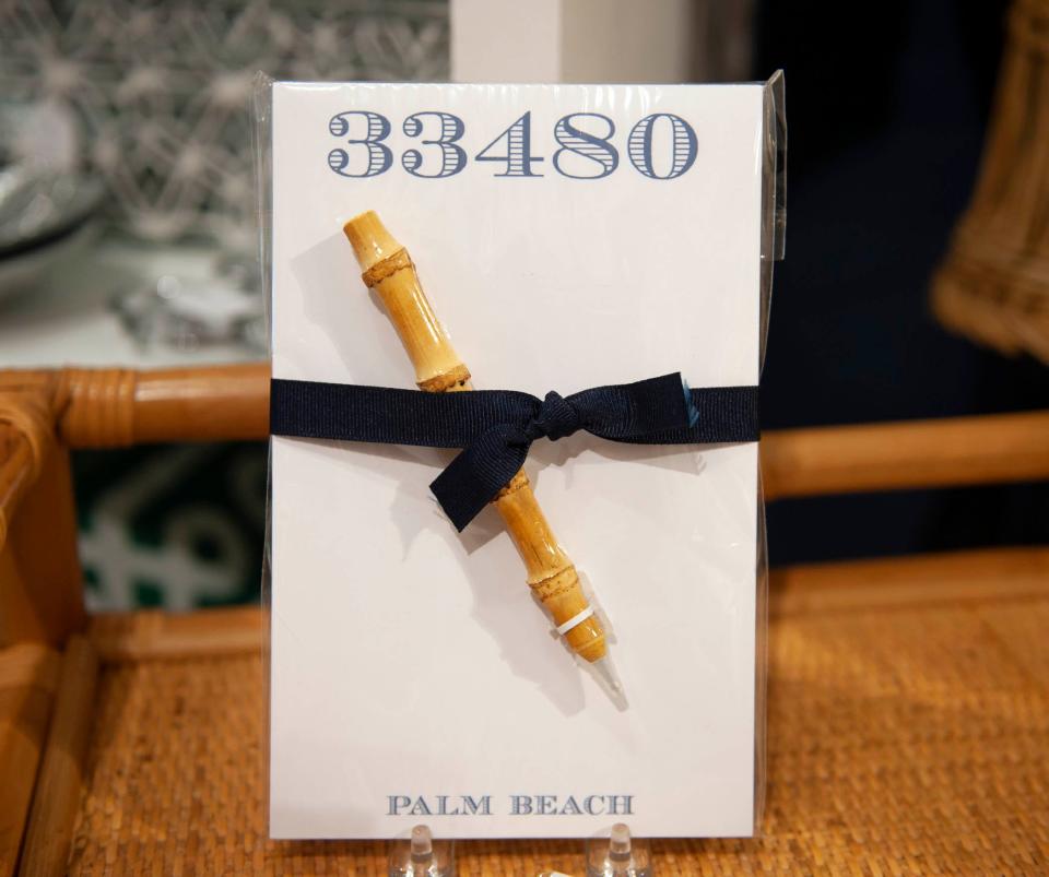 A 33480 writing pad and a bamboo pen are among the uniquely Palm Beach items for sale at KELLER.