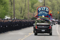 Thousands of police officers line the street as the funeral procession of New York police officer Anastasios Tsakos leaves the St. Paraskevi Greek Orthodox Shrine Church, Tuesday, May 4, 2021, in Greenlawn, N.Y. Tsakos was at the scene of an accident on the Long Island Expressway when he was struck and killed by an allegedly drunk driver a week ago. (AP Photo/Mark Lennihan)