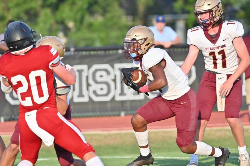 St. Augustine running back Devonte Lyons takes the handoff and gains some yards during a spring game against Bishop Kenny, Thursday, May 19, 2022.