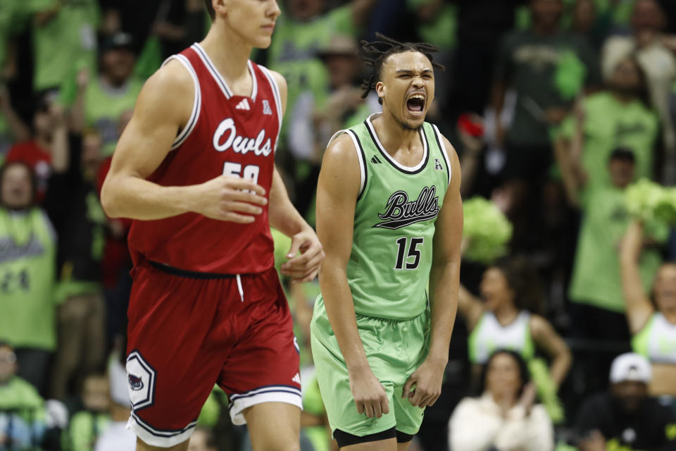 South Florida forward Corey Walker Jr., right, reacts after making a basket during the second half of an NCAA college basketball game against Florida Atlantic, Sunday, Feb. 18, 2024, in Tampa, Fla. (AP Photo/Scott Audette)