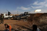 Rebel fighters in Marea city shoot a weapon towards Syria Democratic Forces (SDF) controlled Tell Rifaat town, northern Aleppo province, Syria October 21, 2016. REUTERS/Khalil Ashawi