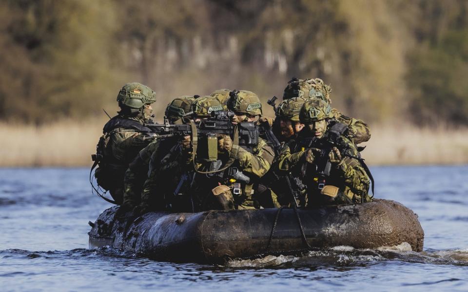 Czech and German soldiers put a rubber dinghy into the river Elbe as part of the military exercise Wettiner Schwert near Tangermuende, 26 03 2024