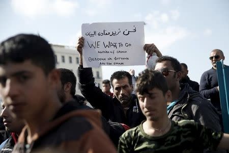 Stranded refugees and migrants stage a protest demanding to be allowed to cross the Greek-Macedonian border at the port of Piraeus, near Athens, Greece, February 26, 2016. REUTERS/Alkis Konstantinidis