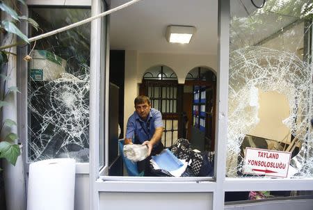 A man removes stones at the Thai honorary consulate in Istanbul, Turkey, July 9, 2015. REUTERS/Osman Orsal