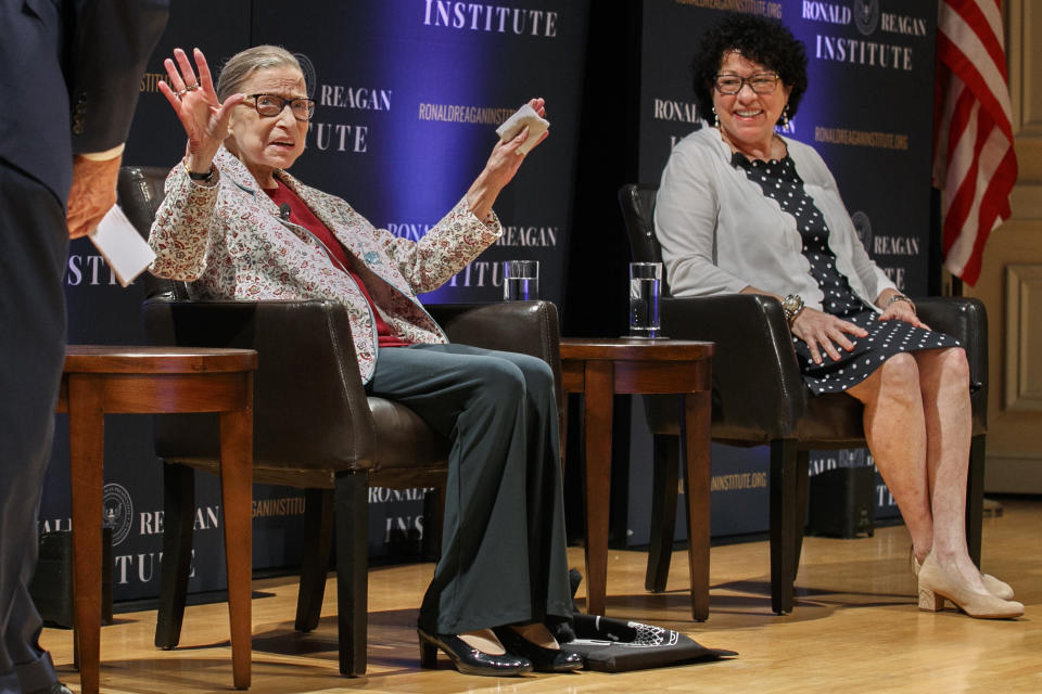 Supreme Court Justice Ruth Bader Ginsburg, left, holds up her hands as she and Supreme Court Justice Sonia Sotomayor arrive to applause for a panel discussion celebrating Sandra Day O'Connor, the first woman to be a Supreme Court Justice, Wednesday Sept. 25, 2019, at the Library of Congress in Washington. (AP Photo/Jacquelyn Martin)