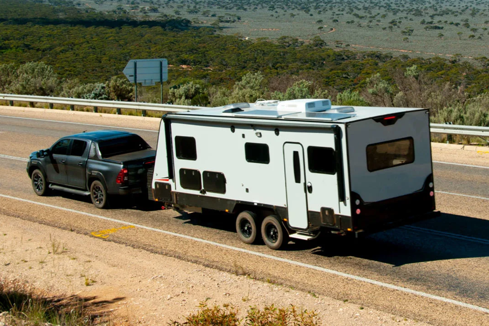 A utility towing a caravan on an Aussie highway. 