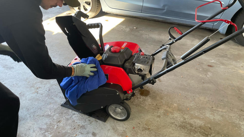 Wiping down snow blower after rinsing