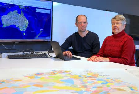 A supplied image shows University of Newcastle research academic, Professor Lyndall Ryan, and researcher Bill Pascoe sitting in front of a screen July 18, 2018, displaying a map detailing the number of Aboriginal and Torres Strait Islander massacres that occurred on Australia’s colonial frontier. Picture taken July 18, 2018. University of Newcastle/Handout via REUTERS