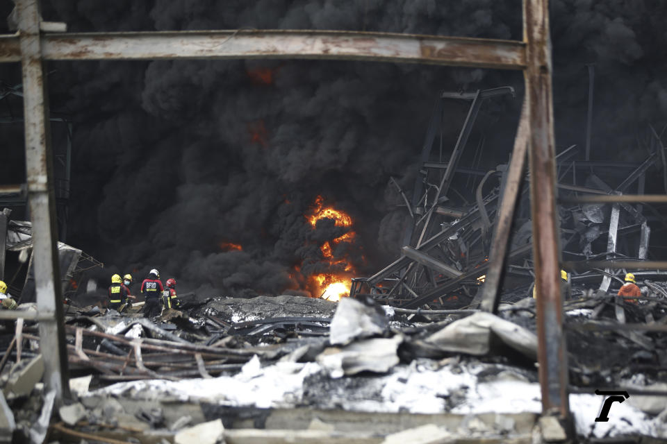 Firefighters work at the site of a massive explosion in Samut Prakan province, Thailand, Monday, July 5, 2021. A massive explosion at a factory on the outskirts of Bangkok has damaged homes in the surrounding neighborhoods and prompted the evacuation of a wide area over fears of poisonous fumes from burning chemicals and the possibility of additional denotations. At least one person has been killed and dozens have been injured. (AP Photo)