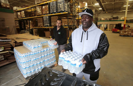 FILE PHOTO: Anthony Fordham picks up bottled water from the Food Bank of Eastern Michigan to deliver to a school after elevated lead levels were found in the city's water in Flint, Michigan December 16, 2015. REUTERS/Rebecca Cook/File Photo