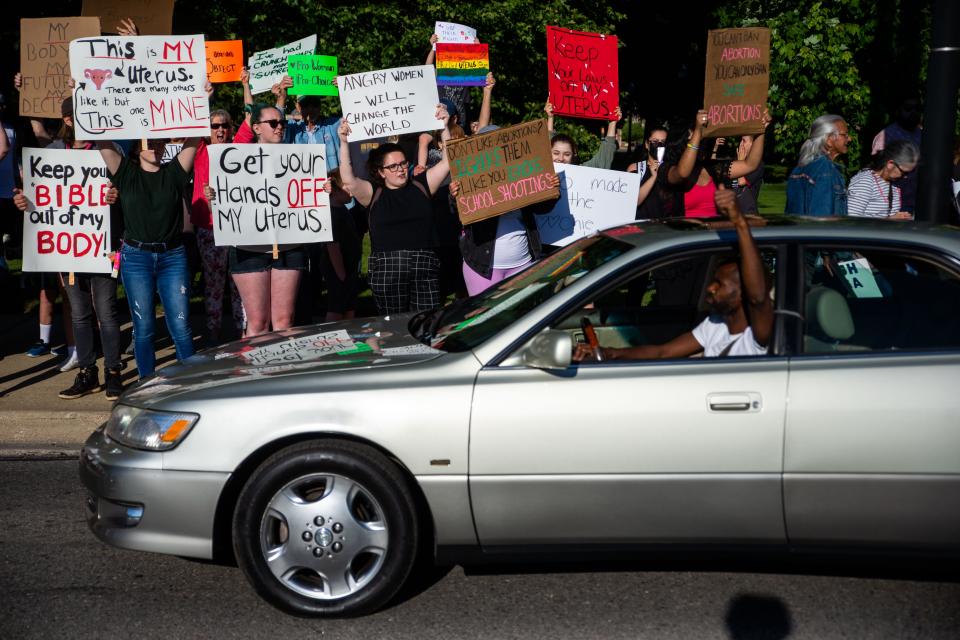 Drivers honk their horns in support of abortion rights during a protest in response to last week's Supreme Court decision overturning Roe v. Wade Monday, June 27, 2022, in downtown Holland.